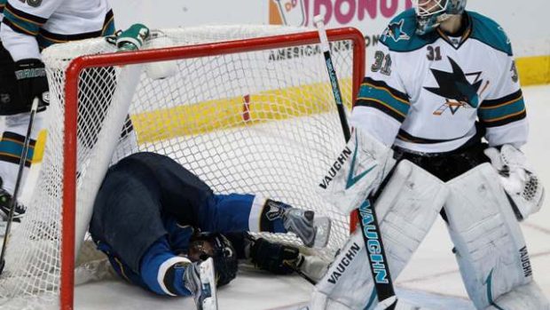 San Jose Sharks goalie Antti Niemi (R) looks back at St. Louis Blues center Vladimir Sobotka, who is upside down in the net, during their NHL Western Conference quarter-final playoff hockey game