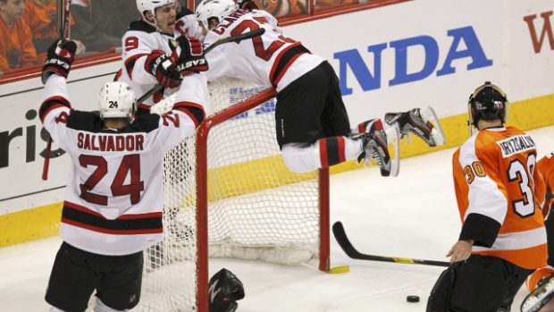 New Jersey Devils&#039; David Clarkson  (23) celebrates with teammates Zach Parise (9) and Bryce Salvador after scoring on Philadelphia Flyers goalie Ilya Bryzgalov in NHL semifinal hockey game