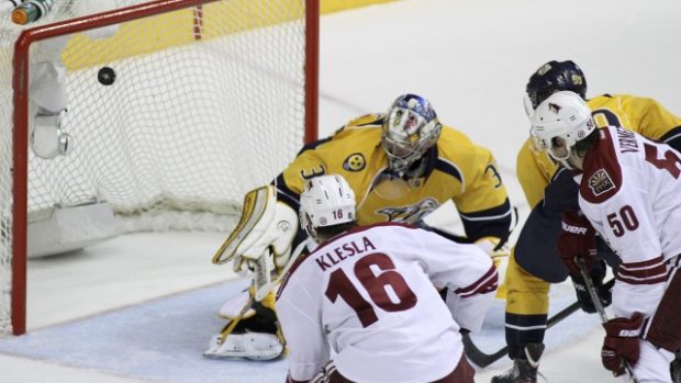 Phoenix Coyotes defenseman Rostislav Klesla (16) and Phoenix Coyotes center Antoine Vermette (50) watch a shot from teammate Phoenix Coyotes right wing Shane Doan  (19) get past Nashville Predators goalie Pekka Rinne