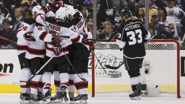 New Jersey Devils  Ilya Kovalchuk (2nd R) celebrates with teammates Bryce Salvador (L), Andy Greene (2nd L) Zach Parise (C) as Los Angeles Kings Willie Mitchell (R) skates by after scoring an empty net goa in Game 4 of the NHL Stanley Cup, June 6, 2012