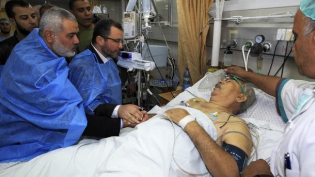 Egyptský premiér Hišám Kandíl (uprostřed) navštívil v Gaze pacienta zraněného během izraelského útoku