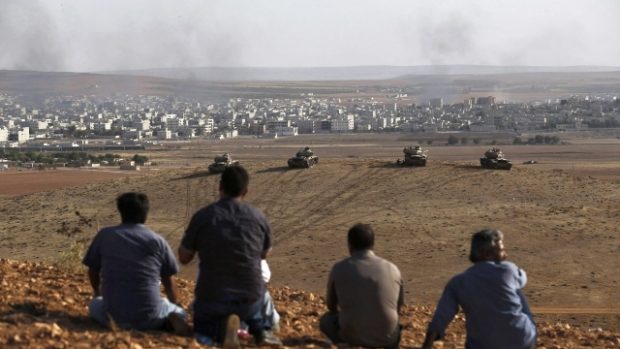 Turečtí Kurdové sledují kouř stoupající z pohraničního města Kobani