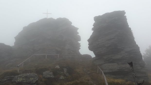 Dřevěný kříž je na skalnatém vrcholu hory Vozka v Jeseníkách