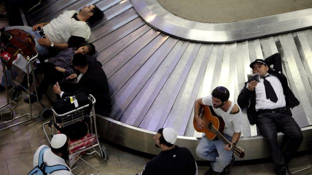 Cestující čekající na svoje zavazadla na letišti v izraelském Tel Avivu