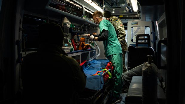 Sanitka na Ukrajině podává raněným vojákům první lékařskou pomoc