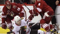 Chicago Blackhawks left wing Andrew Brunette (15) is hit to the ice by Phoenix Coyotes center Gilbert Brule (8) and defenseman Rostislav Klesla  (16) during Game 1 of the NHL Western Conference quarter-final hockey playoffs