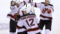 New Jersey Devils center Adam Henrique (hidden) is mobbed by teammates after scoring the game-winning goal against the Florida Panthers in double overtime during Game 7 of their NHL Eastern Conference quarter-final playoff hockey game