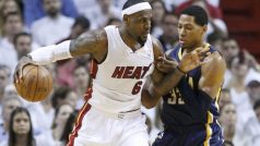 Miami Heat&#039;s LeBron James  (L) dribbles against Indiana Pacers&#039; Danny Granger in the first quarter during Game 5 of their NBA Eastern Conference second round basketball playoff series in Miami, Florida May 22, 2012