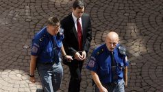 Policisté přivádějí obviněného Davida Ratha do jednací síně Okresního soudu Praha-východ