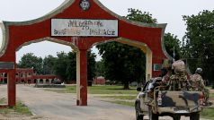 Armádní vozidlo s vojáky projíždí skrze bránu, kde se dříve nacházelo velitelství Boko Haram.