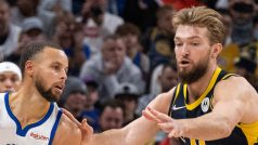 Domantas Sabonis z Indiany brání Stepha Curryho z Golden State