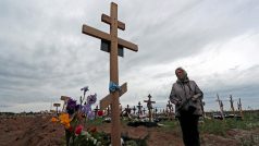 Žena u hrobu syna na pohřebišti u Mariupolu