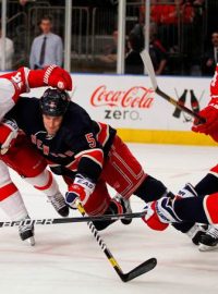 Detroit Red Wings left wing Jiri Hudler (L) and right wing Todd Bertuzzi (2nd R), and New York Rangers defensemen Dan Girardi (2nd L) and Ryan McDonagh battle for the puck in third period action during their NHL hockey game