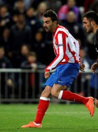 Atletico Madrid&#039;s Adrian Lopez (L) scores past Valencia&#039;s Victor Ruiz during their Europa League  semi-final first leg soccer match against Valencia