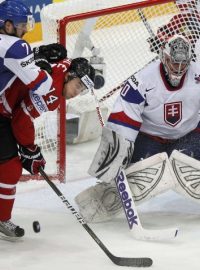 Slovakia&#039;s goalkeeper Jan Laco  (R) and Ivan Baranka (L) fight for puck with Canada&#039;s Jordan Eberle during their 2012 IIHF men&#039;s ice hockey World Championship quarter-final game in Helsinki  May 17, 2012