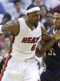 Miami Heat&#039;s LeBron James  (L) dribbles against Indiana Pacers&#039; Danny Granger in the first quarter during Game 5 of their NBA Eastern Conference second round basketball playoff series in Miami, Florida May 22, 2012