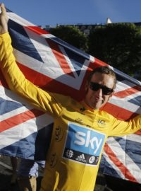 Bradley Wiggins, winner of the 2012 Tour de France cycling race, holds the Union flag during the team parade of the the Tour de France cycling race in Paris, France, Sunday July 22, 2012