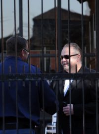 Radovan Krejčíř zdraví policistu před budovou pretorijského soudu, který 29. srpna rozhodoval o vydání Krejčíře do Česka