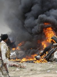Šíitské milice na jižním okraji iráckého města Tikrít. Na snímku je vidět hořící vůz, který řídil sebevražedný atentátník hlásící se k Islámskému státu