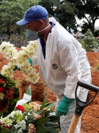 Pracovníci v ochranných oblecích zakopávají rakve se zemřelými na koronavirus na největším brazilském hřbitově Vila Formosa