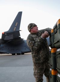 Ukrajinský voják vybaluje pomoc z Litvy