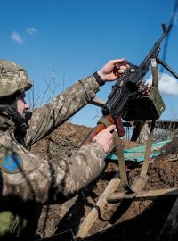 Ukrajinský voják upevňuje v zákopu kulomet