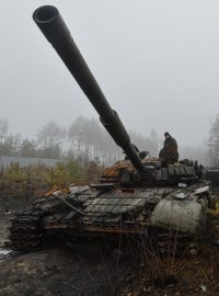 Ukrajinci prohlížení zničený ruský tank u obce Dmytrivka na severu země